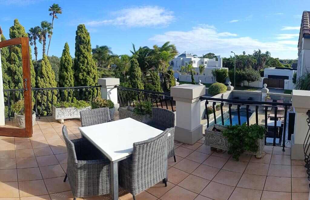 Terrace with outdoor dining area and garden view